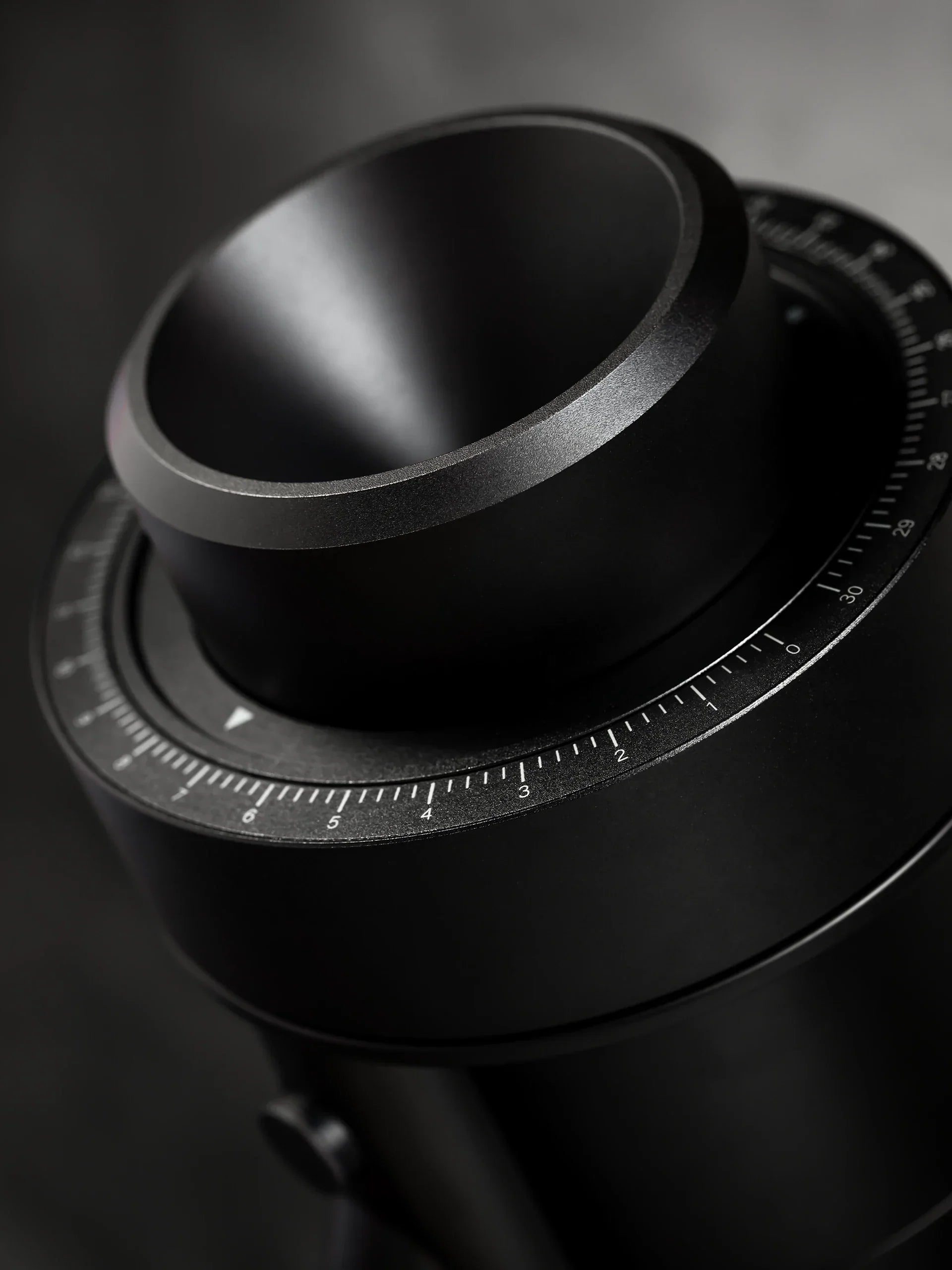 Close-up of the WPM ZP1 Single Dose Grinder's stepless grind collar, showcasing its sleek black design.